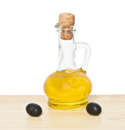 Bottle of olive oil and olive fruits on tableの写真素材