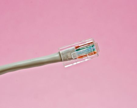 RJ45 (ethernet) plug isolated on pink backgroundの写真素材