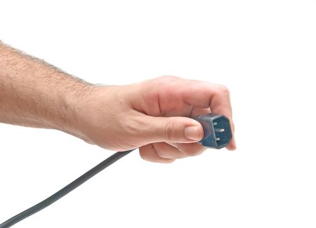 Hand with three-pin power plugの写真素材
