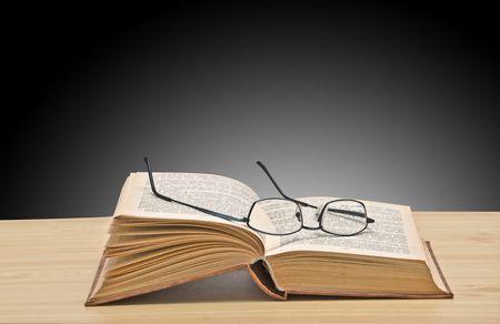 Eyeglasses on open bookの写真素材