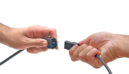 Hands with three-pin power male and female connectorsの写真素材