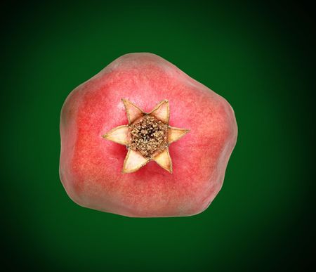 Ripe pomegranate  isolated on green background