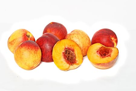 Peaches and sections isolated on white backgroundの写真素材