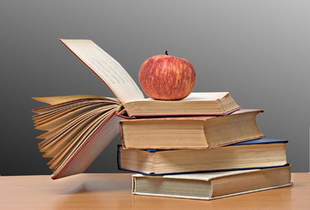 Red apple and books on deskの写真素材