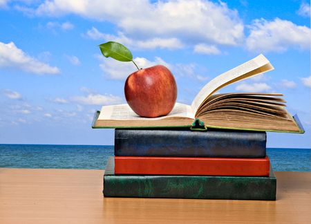 Red apples and open bookの写真素材