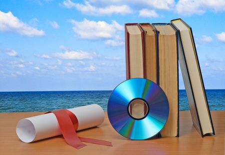 Scroll with red ribbon and books
