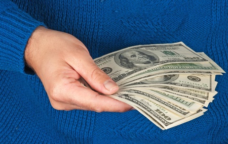 Hand with dollar bills isolated on background