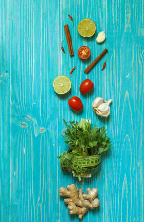 vegetables, spices, lemons and ingredients for healthy eating and weight loss on a blue wooden background. Top viewの写真素材