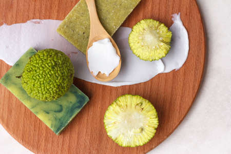 natural green soap from the fruit of osage apple or maclura, a plant with healing properties, top viewの写真素材