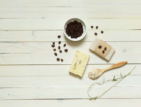 Two types of natural scrub soap with coffee and oat flakes. Top view on a light wood surface with spaceの写真素材