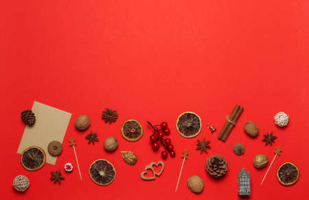 New year red background with festive decor, decorations, gilded nuts and toys. Copy of the space