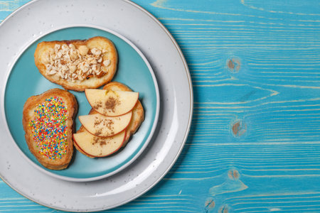 Toast fried in a mixture of eggs, milk and sugar, French toast with Apple slices, nuts, pastry sprinkles. The concept of a healthy Breakfast, lunch. Fried breadの写真素材