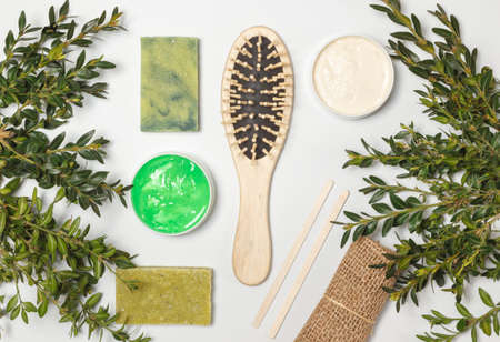 Products for skin and hair care, eco-friendly wooden comb, soap with herbal extracts. Layout on a white backgroundの写真素材