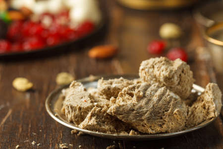 An airy halva made from peanuts and whipped caramel. Oriental sweetness on a copper plate and a tray...