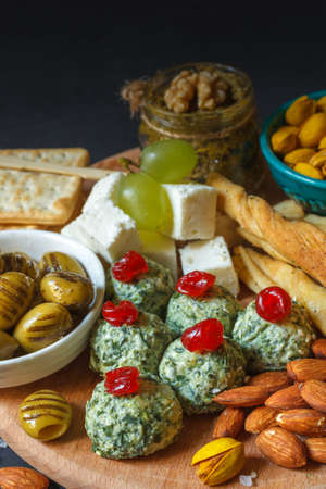 A set of healthy vegetarian snacks on a wooden board, close up, selective focus.の写真素材