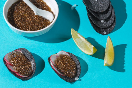 An original and healthy snack. Black chips with natural charcoal and sea salt with chia seed caviar...