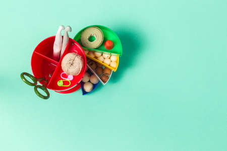 Organization of space for needlework, hobbies. Plastic organizer for accessories with color dividers. Overhead, Copy space, horizontalの写真素材