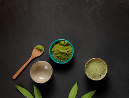 Matcha tea in bowls, with whipped foam. Flatlay on a black background. Horizontal, copy space