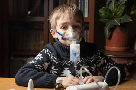 The child inhales, inhales through the mask a solution to relieve cough. Portrait.