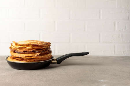 A stack of thin pancakes in a frying pan. Horizontal with a copy of the space.の写真素材