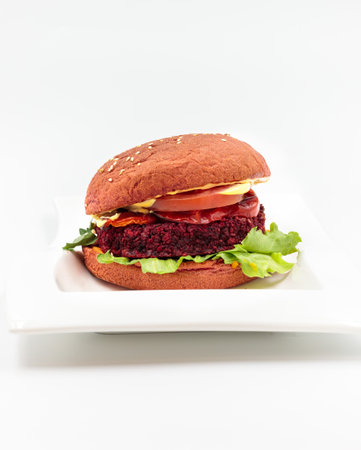 Vegan burger with beetroot cutlet, vegetables and grain bun. Isolate on a white background.の写真素材