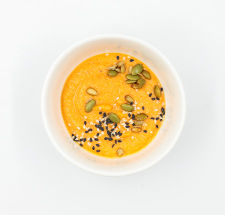 Hummus with seeds in a bowl on a white background. Top view, isolateの写真素材