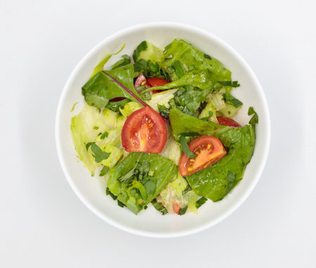 Fresh vegetable salad in a bowl. Isolate on white backgroundの写真素材