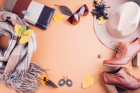 Autumn female outfit. Set of clothes, shoes and accessories on brown background