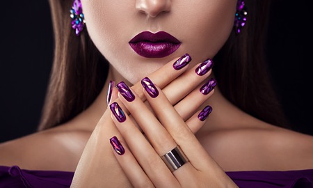 Beautiful woman with perfect make-up and manicure wearing jewelleryの写真素材