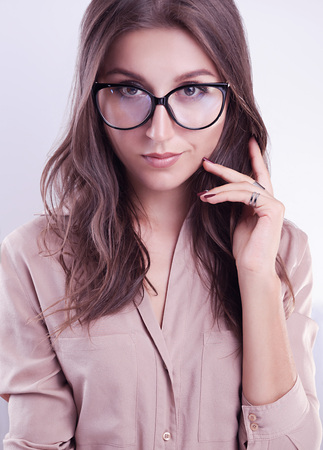 Portrait of a woman in glasses on white backgroundの写真素材