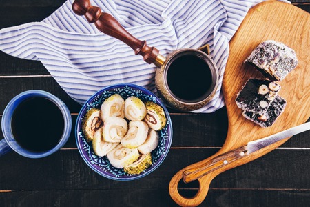 Turkish delight lokum with coffee on black wooden backgroundの写真素材