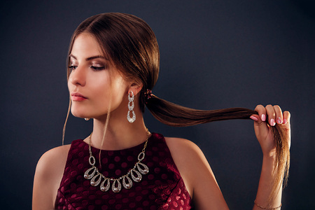 Beautiful woman with long hair on black backgroundの写真素材