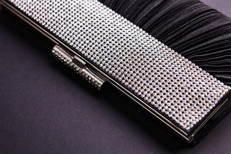 Female cocktail handbag with sparkling stones on black backgroundの写真素材