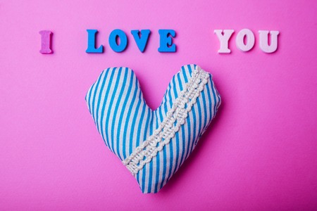 Heart with I love you lettering on pink paper background. Valentine's day concept.の写真素材