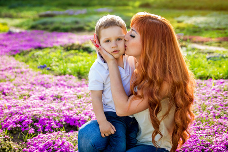 Young mother playing with her little son in spring garden. Mother's Day conceptの写真素材
