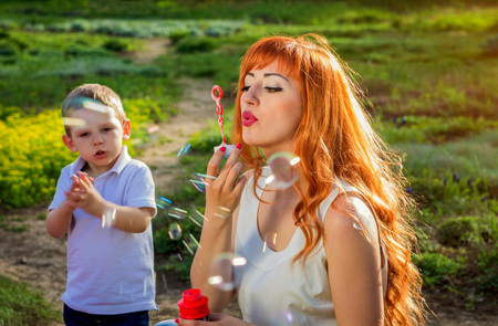 Young mother playing with her little son in spring garden. Mother's Day conceptの写真素材