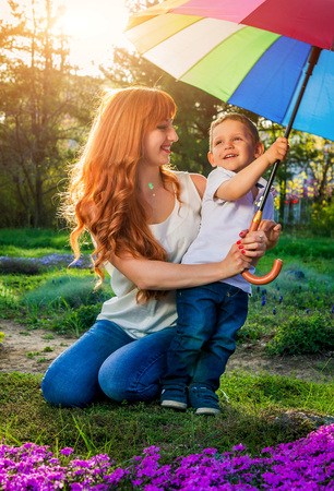 Young mother playing with her little son in spring garden. Mother's Day conceptの写真素材