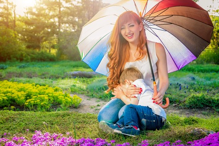 Young mother playing with her little son in spring garden. Mother's Day conceptの写真素材