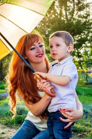 Young mother playing with her little son in spring garden. Mother's Day conceptの写真素材