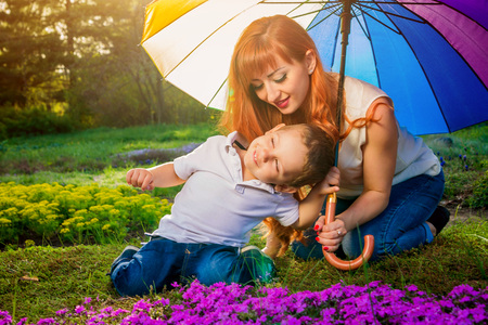Young mother playing with her little son in spring garden. Mother's Day conceptの写真素材