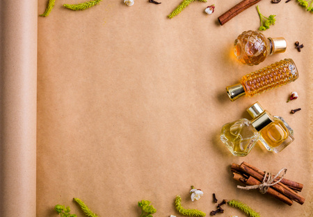 Bottles of perfume with ingredients on paperの写真素材
