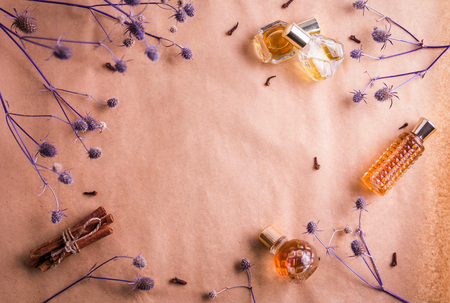 Bottles of perfume with ingredients on paperの写真素材