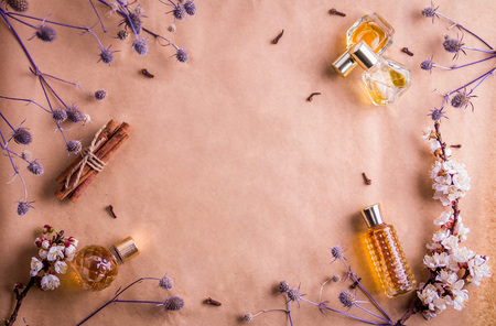 Bottles of perfume with ingredients on paper