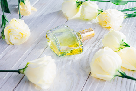 Bottle of perfume with eustoma flowers on white backgroundの写真素材