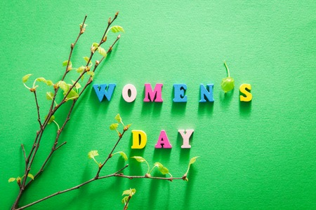 Women's day greeting card. Lettering with birch tree branches on green backgroundの写真素材