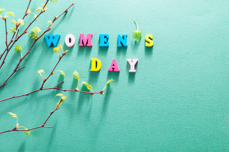 Women's day greeting card. Lettering with birch tree branches on green backgroundの写真素材