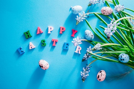 Happy Easter. Easter blue background with spring flowers and eggs