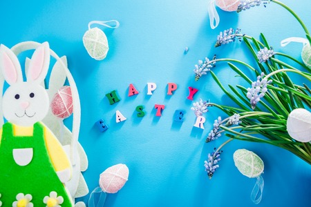 Happy Easter. Easter blue background with spring flowers and eggsの写真素材