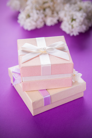 Gift boxes with flowers on purple backgroundの写真素材