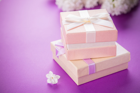 Gift boxes with flowers on purple backgroundの写真素材